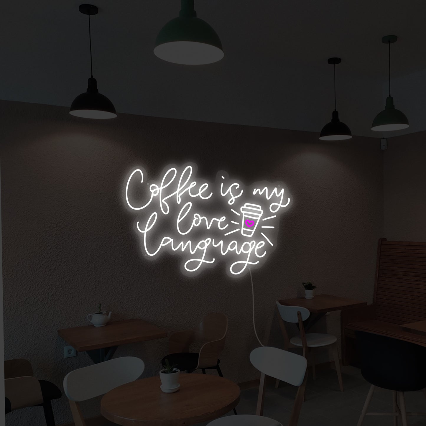 White coffee cup adorned with a small pink heart, representing the sentiment of 'Coffee Is My Love Language