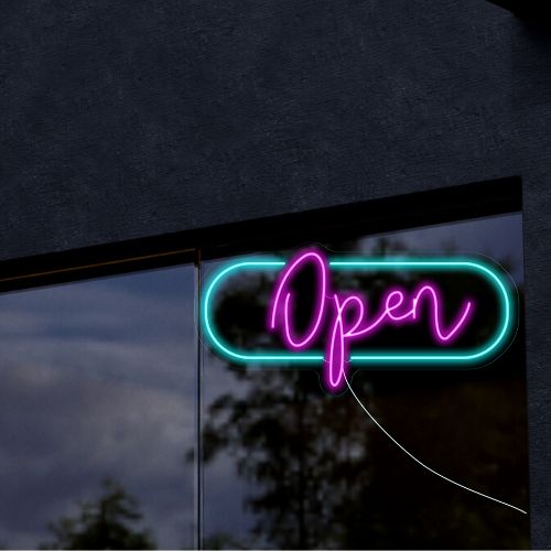 Bright pink and light green neon 'Open' sign hanging in front shop window, inviting customers to enter. Perfect for restaurants, cafes or retail stores
